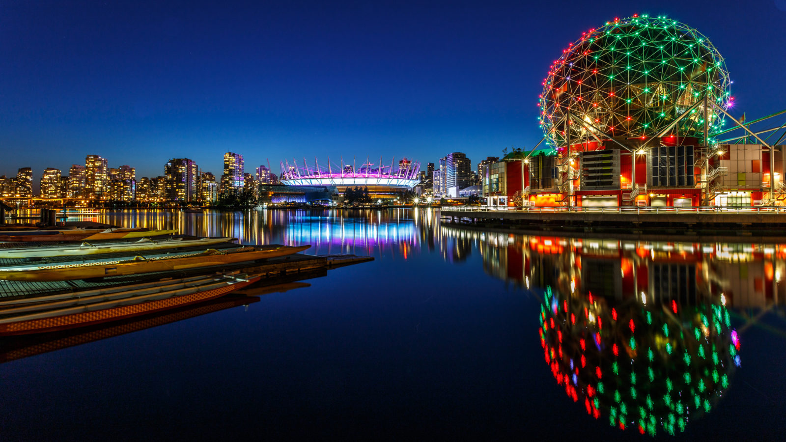 Science World and BC Olympic Place illuminated at night in Vancouver, Canada