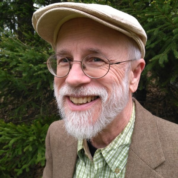 Bespectacled Michael Behe in Green Shirt, Coat, and Cap