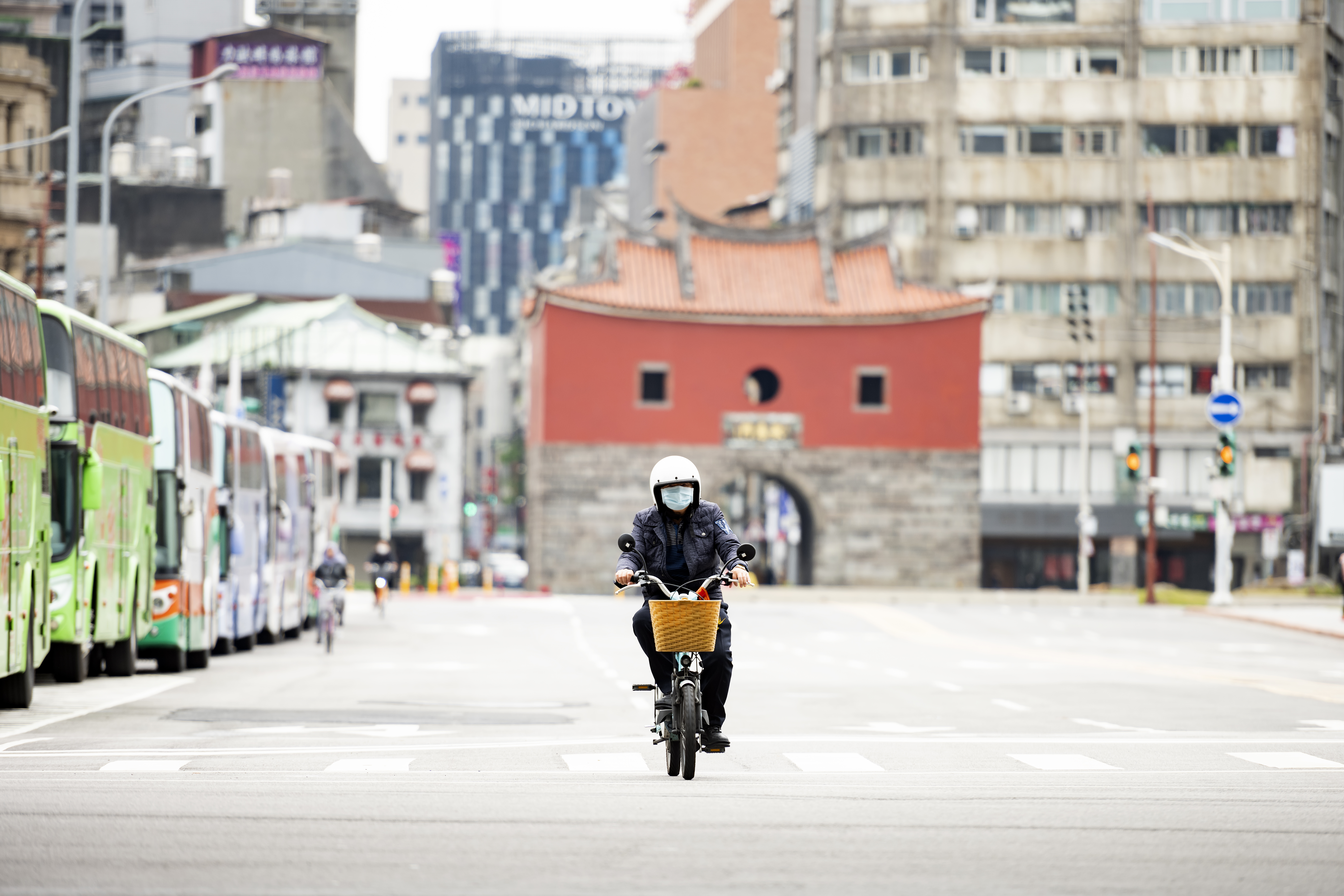 A man, wearing a face mask to protect himself from the novel coronavirus 2019-nCoV or COVID-19 is riding a scooter in Taipei, Taiwan.