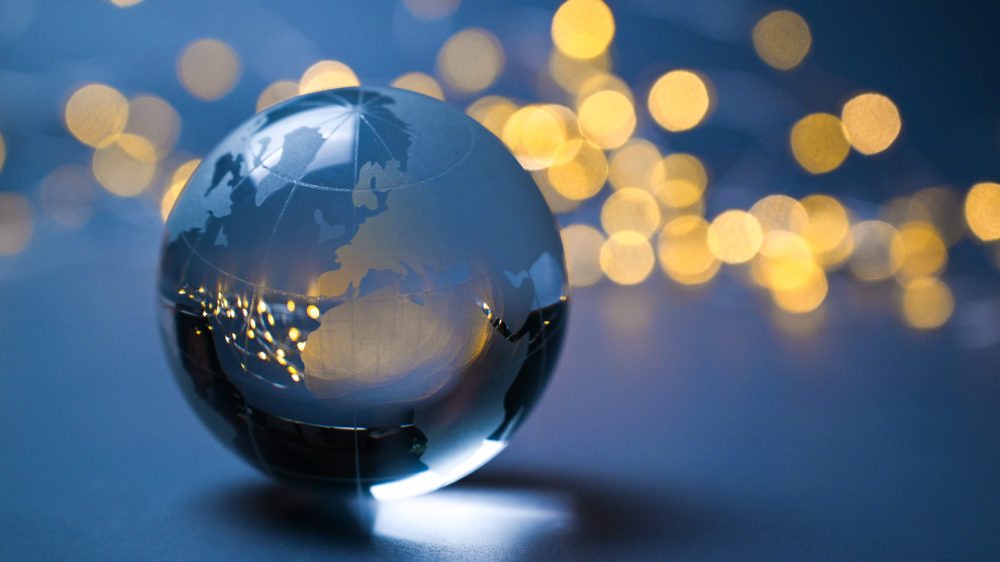 European Union on a glass ball in front of shining lights