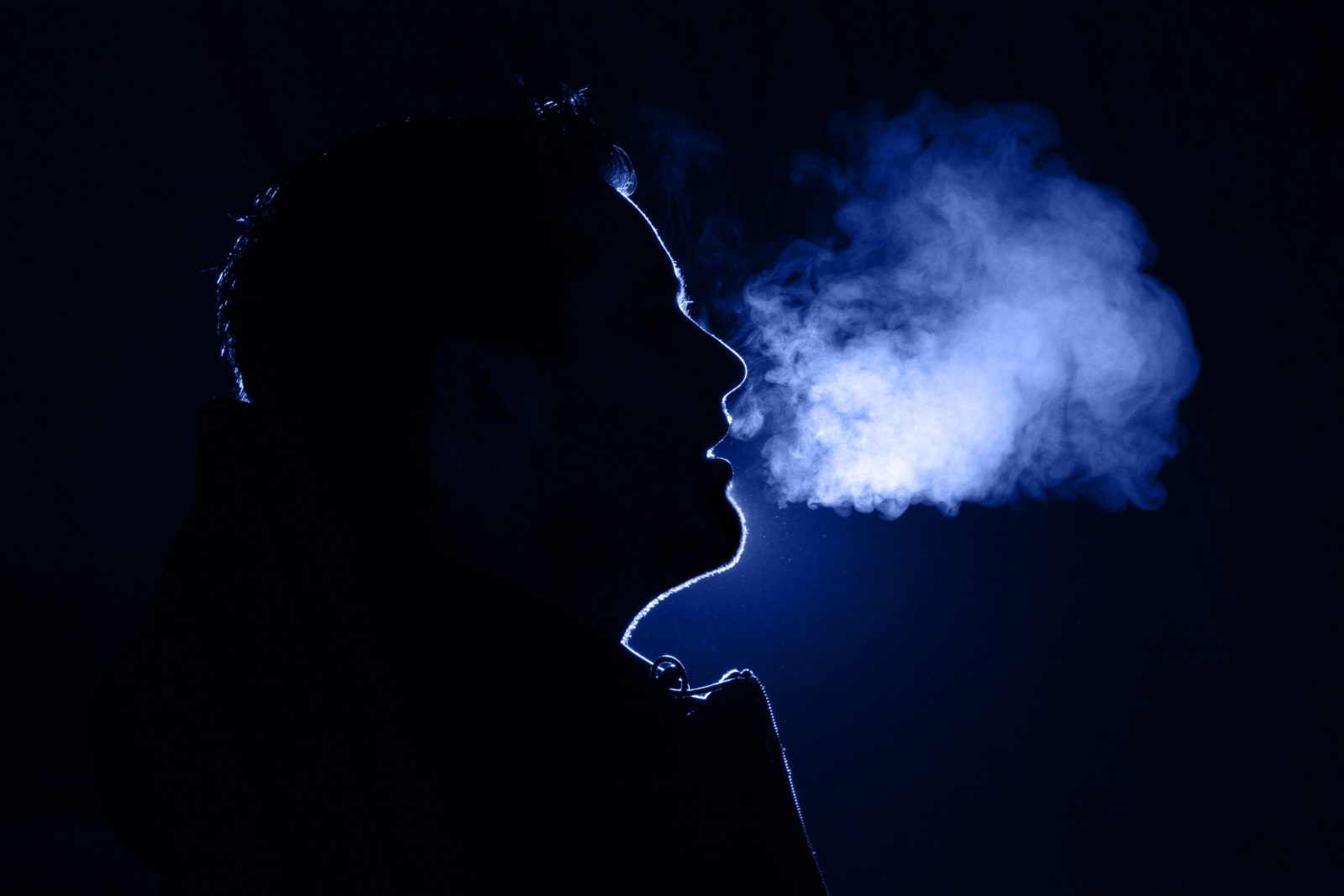 Man exhaling warm breath