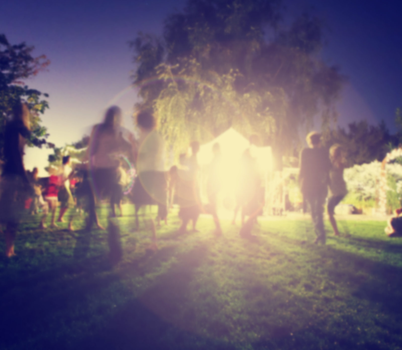 people mingling at a free concert by musicians in a garden