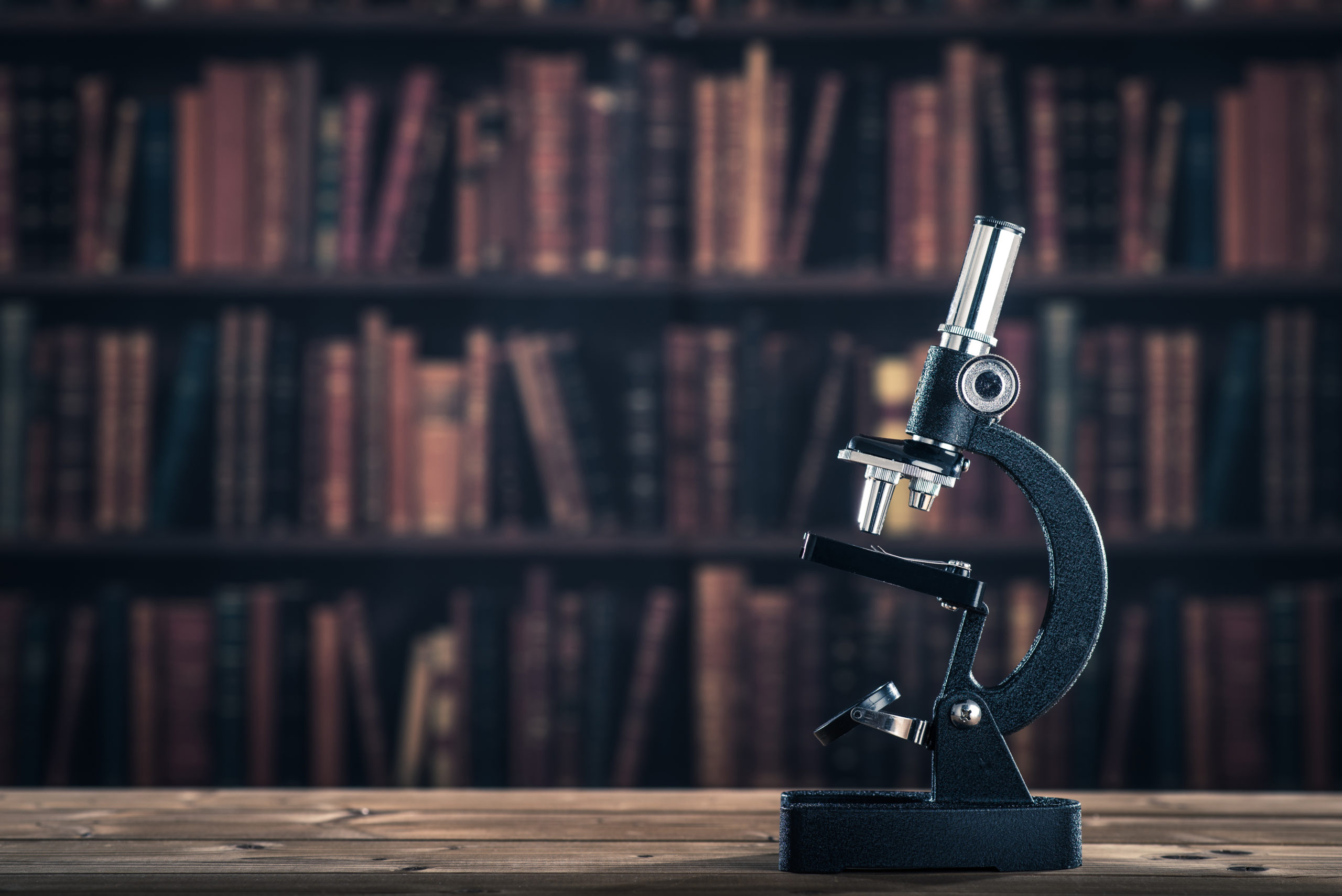 Microscope in library of books