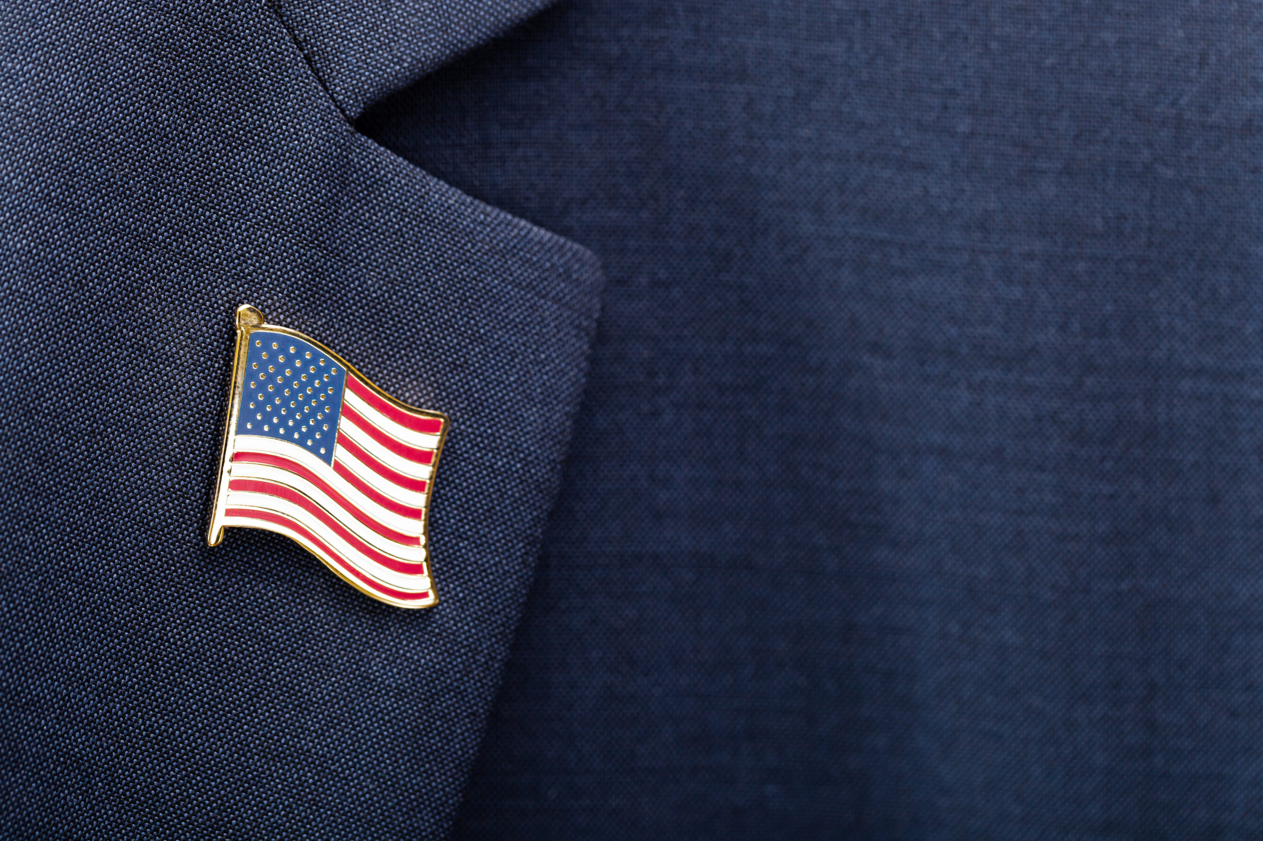 Element of male suit with USA flag pin on chest - studio shot