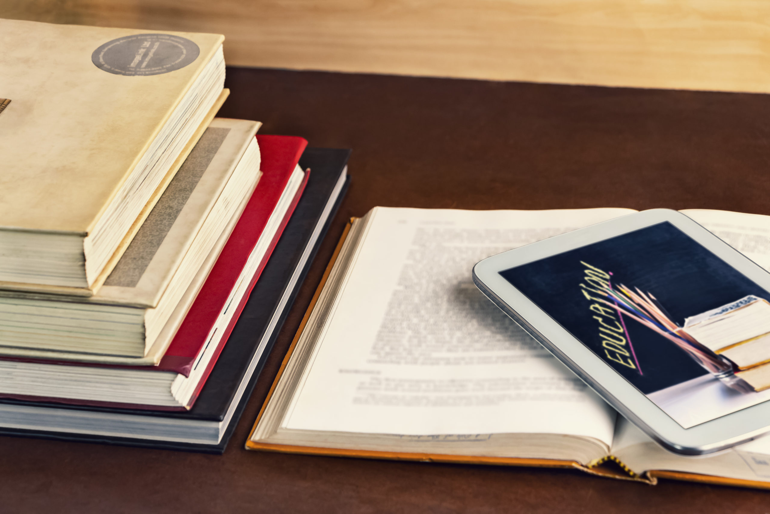 Open textbook and notepad on the table. The concept of intelligence comes from education and can learn a variety of ways.