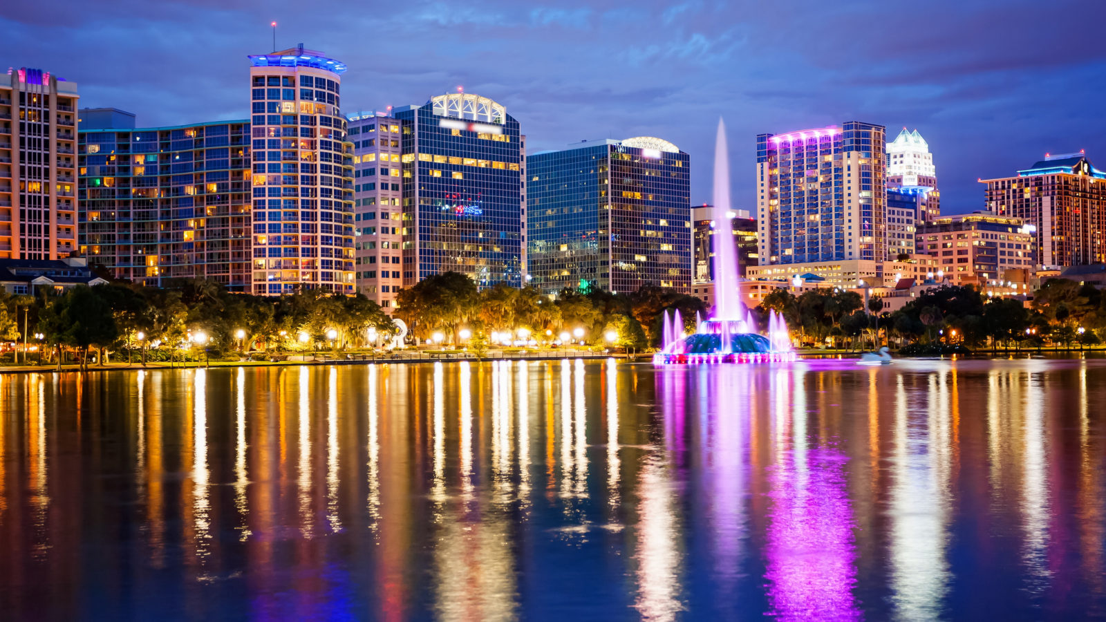 Orlando, Florida City Skyline on Lake Eola at Night (logos blurred for commercial use)