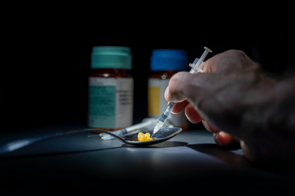 Syringe with cotton and pill bottles. drug abuse.