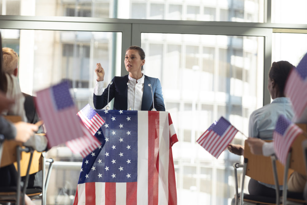 politiician speaking to business people in conference room during meeting