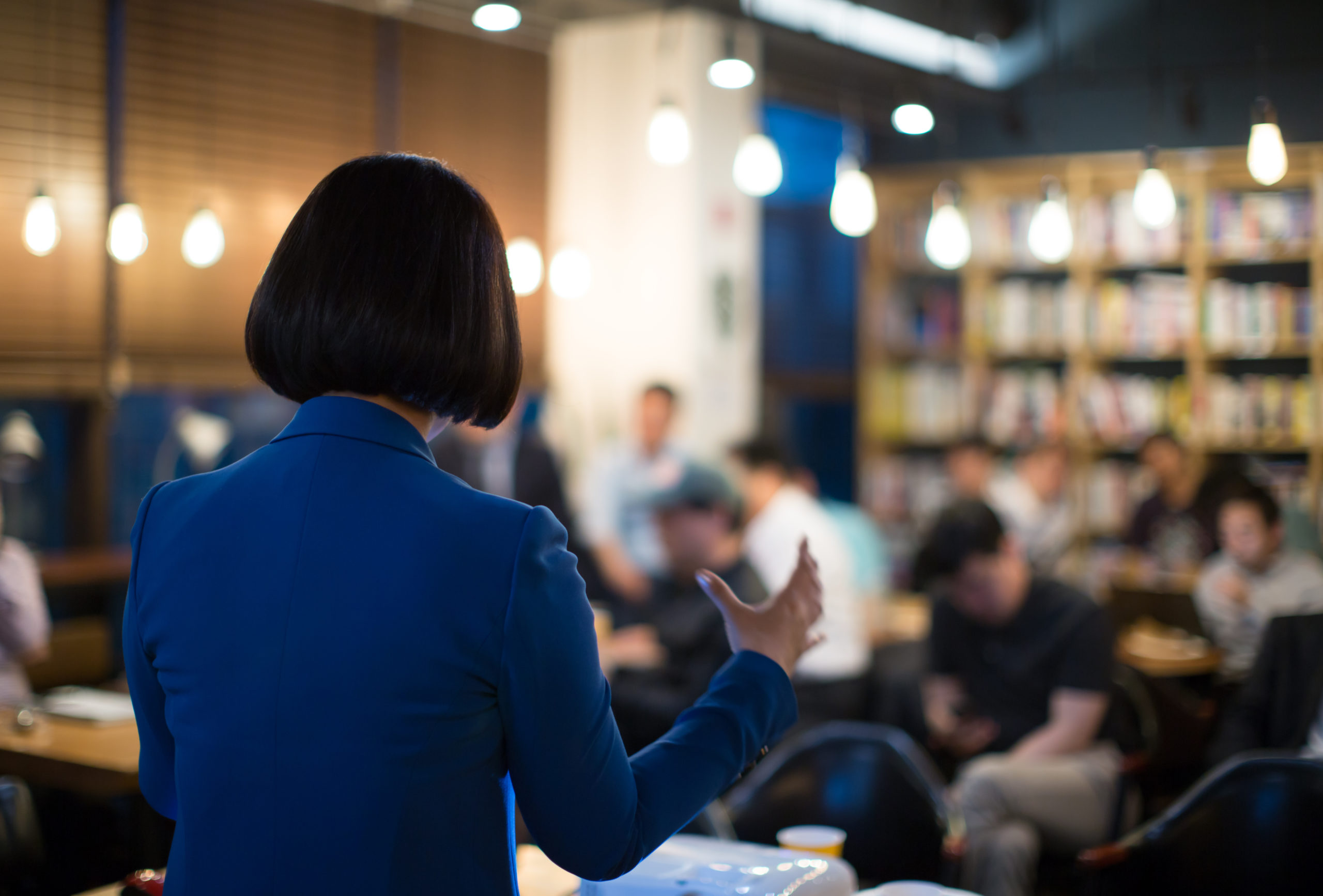 Presenter Giving Presentation at Conference with Investors and MBA Students. Speech during Workshop Teaching Business Tech. Executive Coach Training Corporate Manager. Businesswoman at Pitch Event.