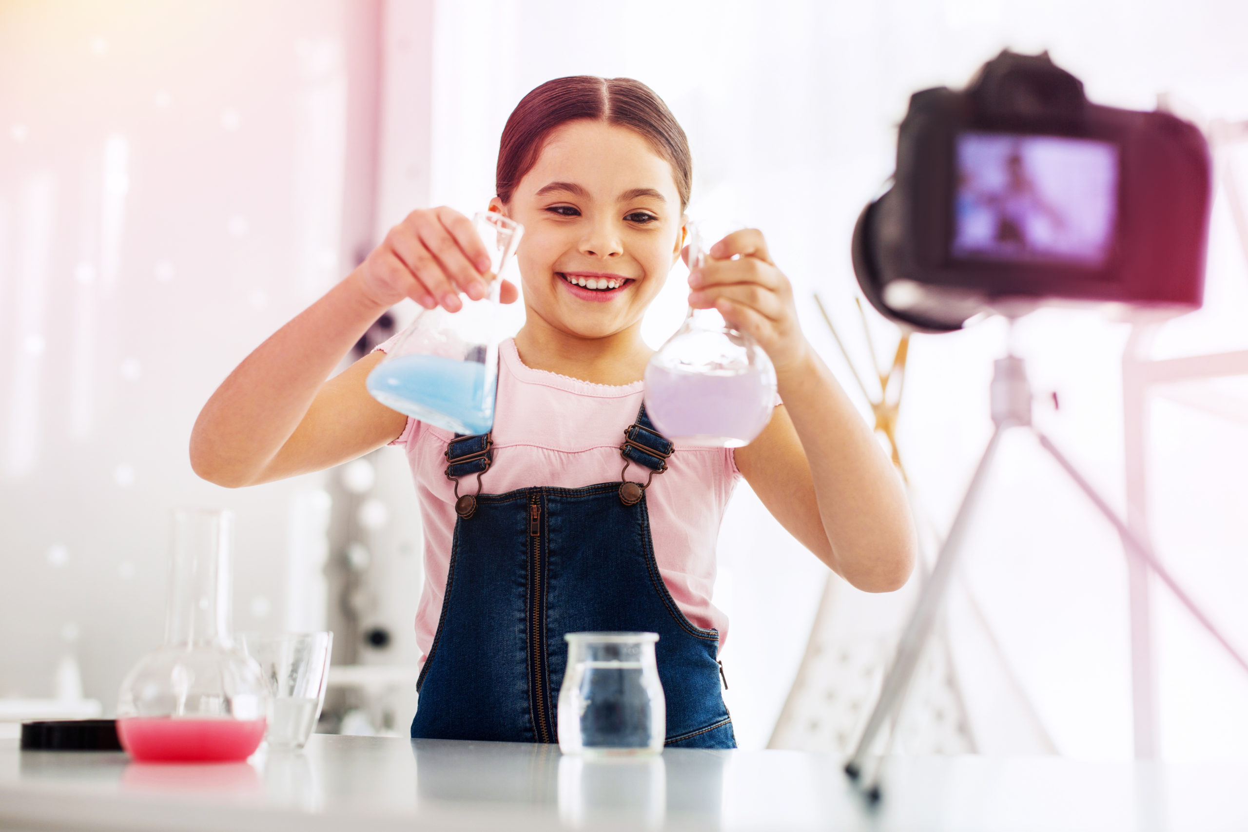 Funny girl fond of chemistry filming video while making experiment