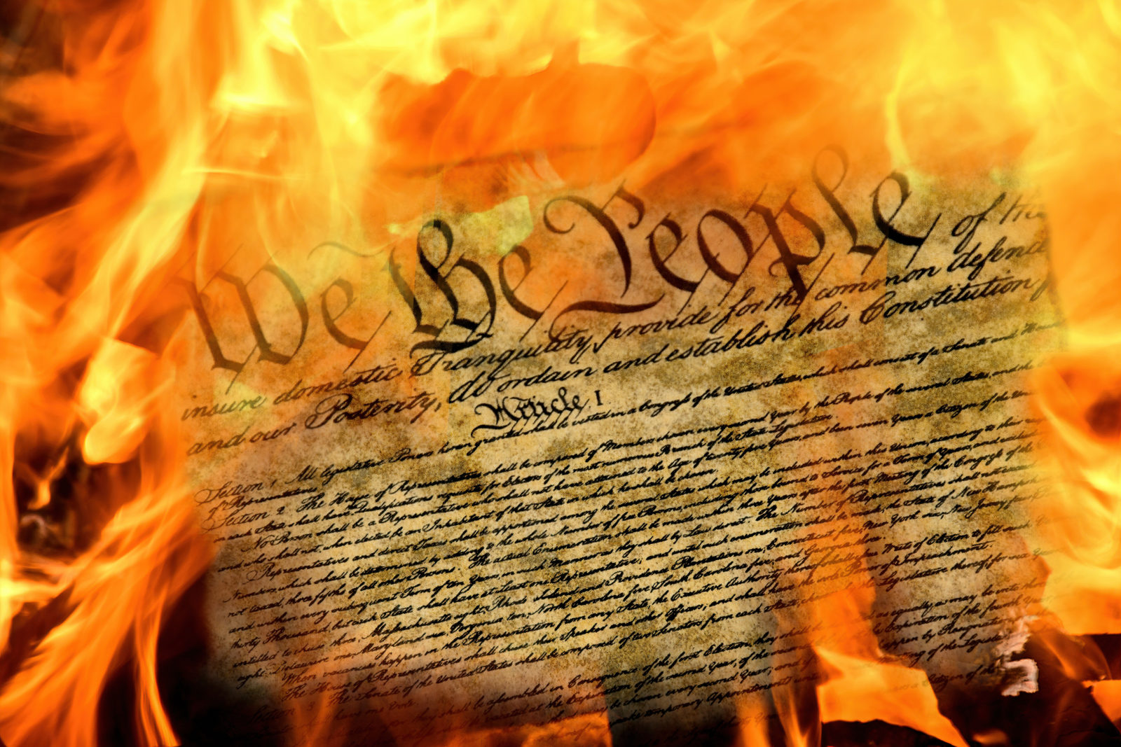 close up of United States constitution document burning in flames