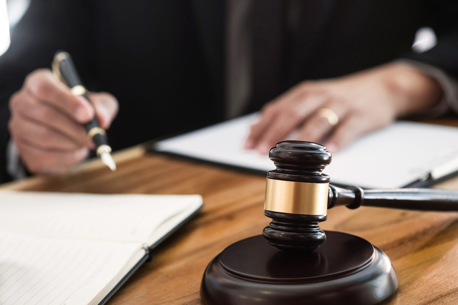 justice lawyer / judge gavel working with legal documents in a court room