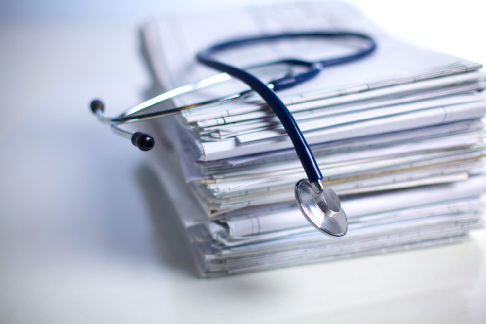books folder file and stethoscope isolated on white background.