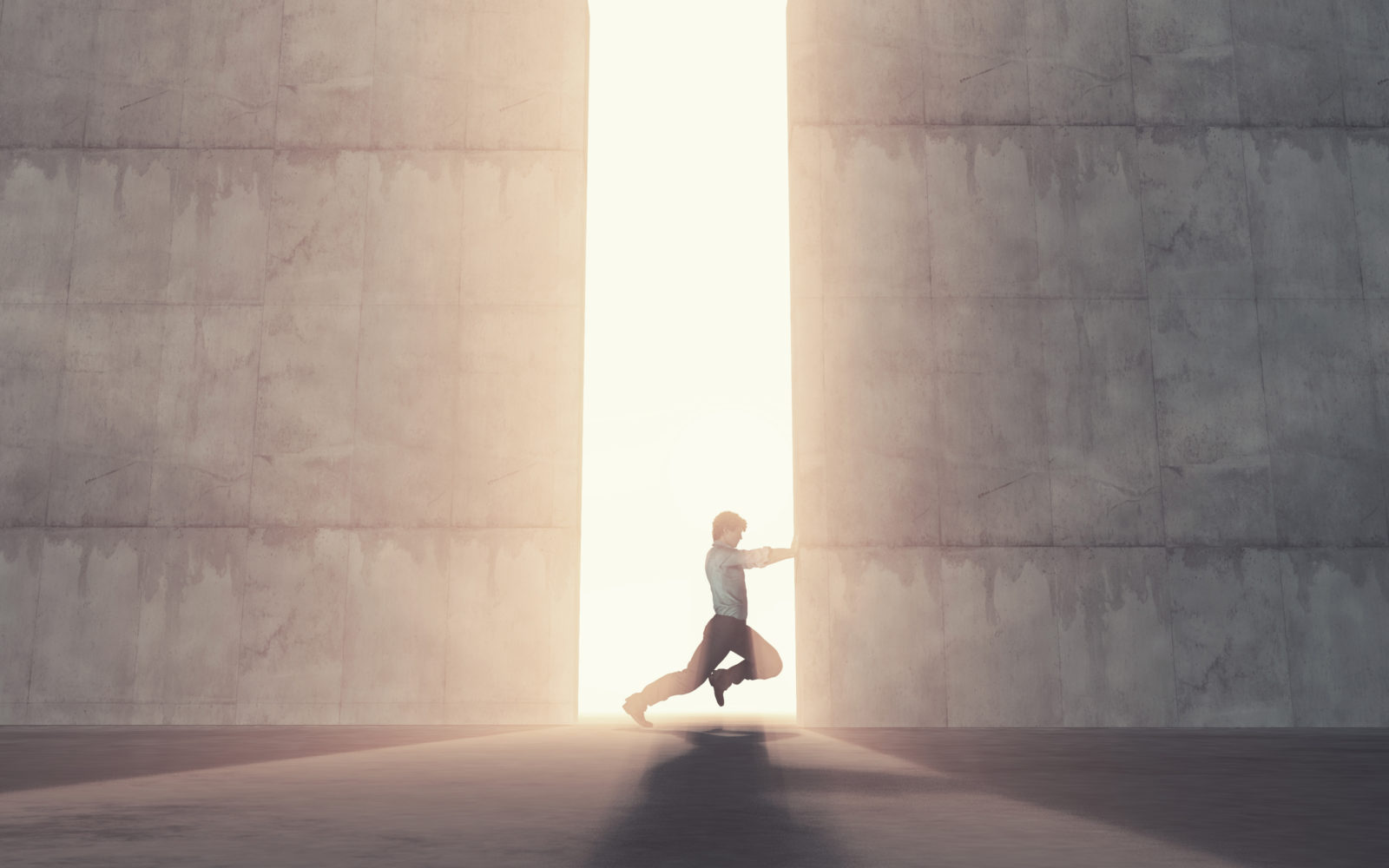 Young man pushing a big door.