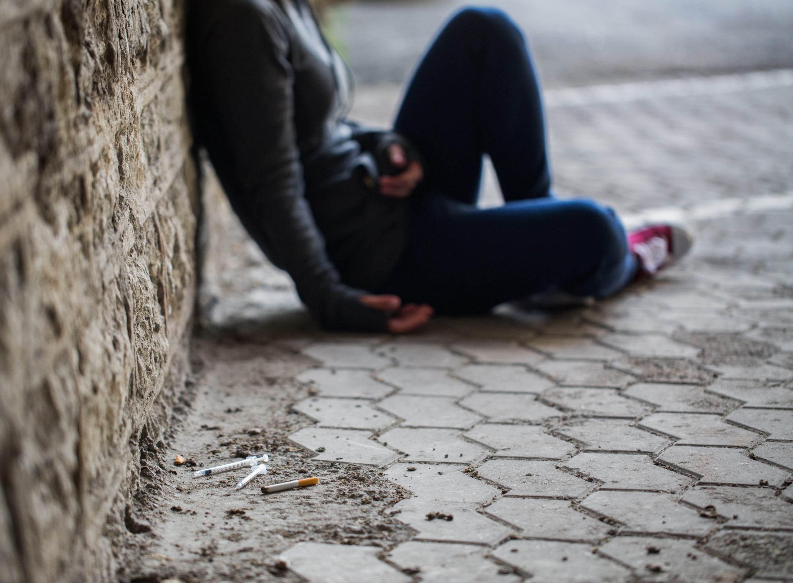 close up of addict woman and drug syringes