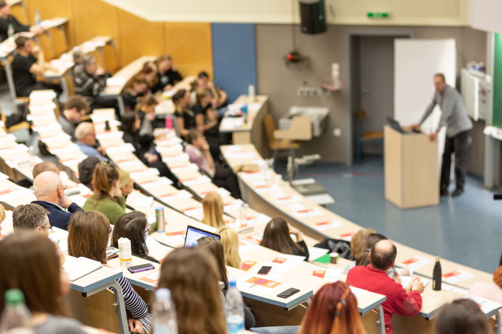 Conference and Presentation. Audience at the conference hall. Business and Entrepreneurship. Faculty lecture and workshop. Audience in the lecture hall. Academic education. Participants making notes.