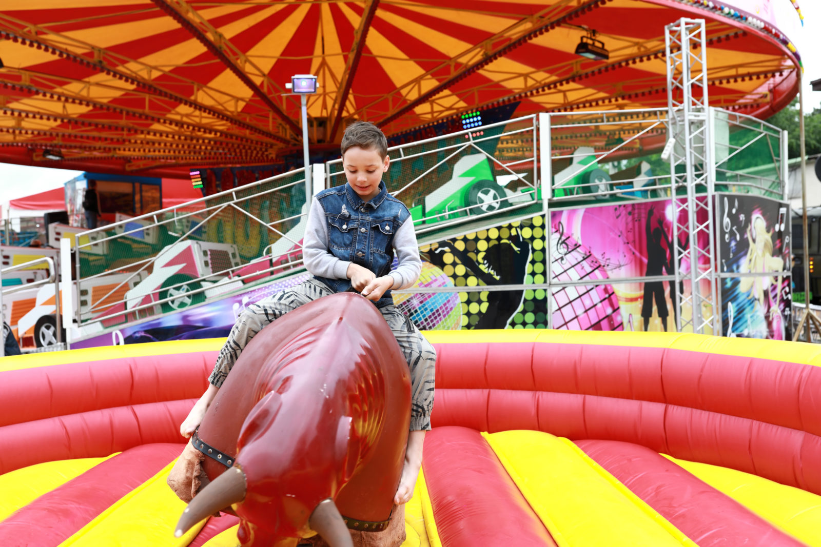 Boy riding on mechanical bull