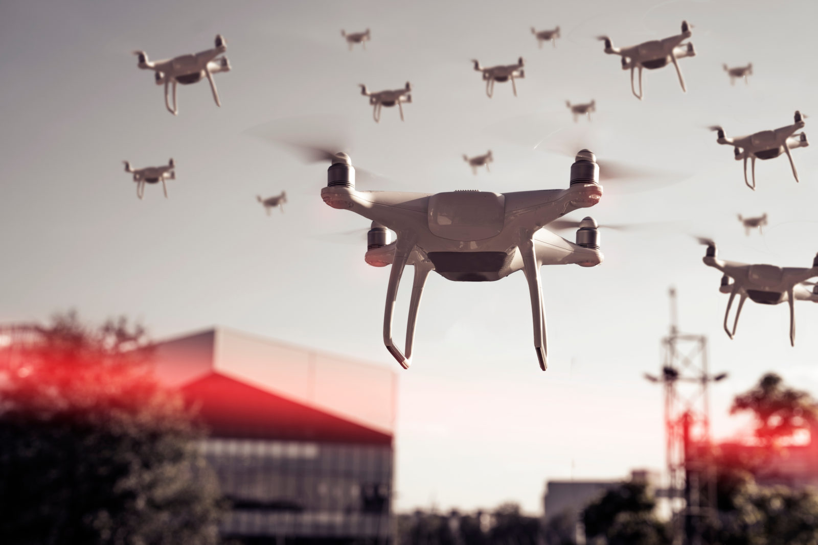 Swarm of drones surveying, flying over city