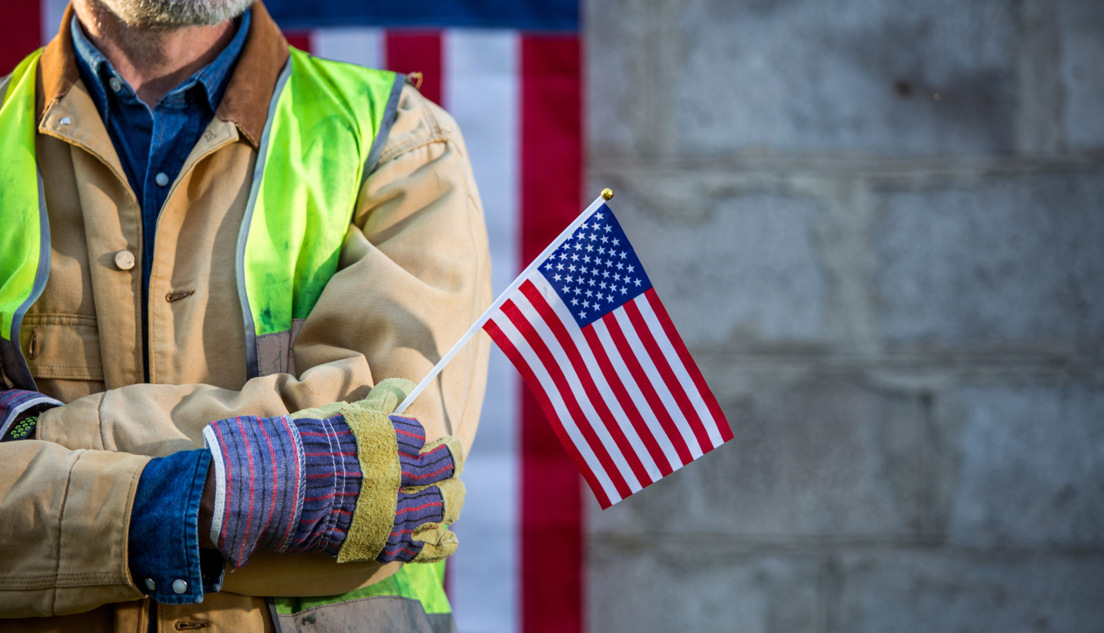 A serious worker man and american flag