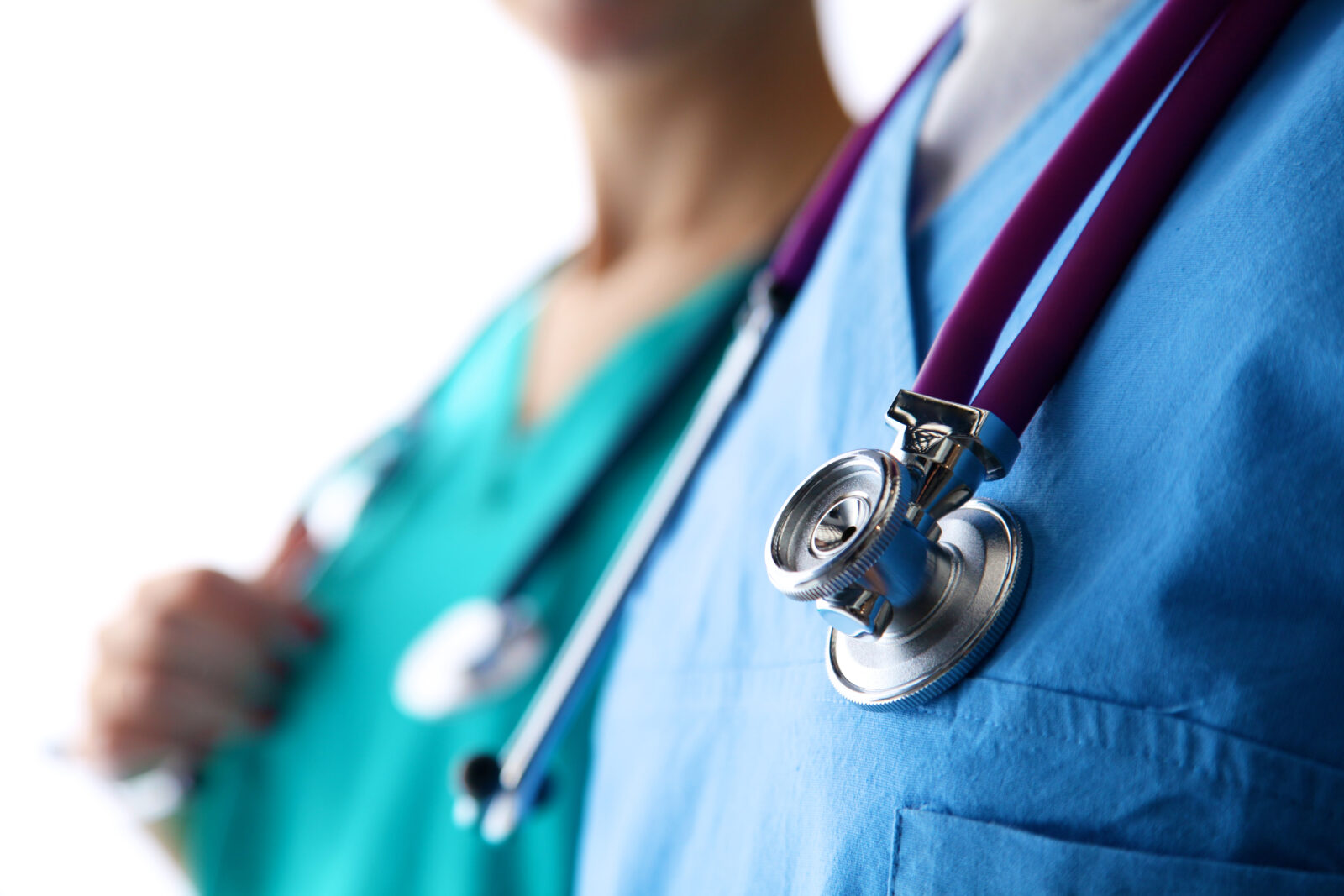 young doctor standing with a stethoscope on a white backgro