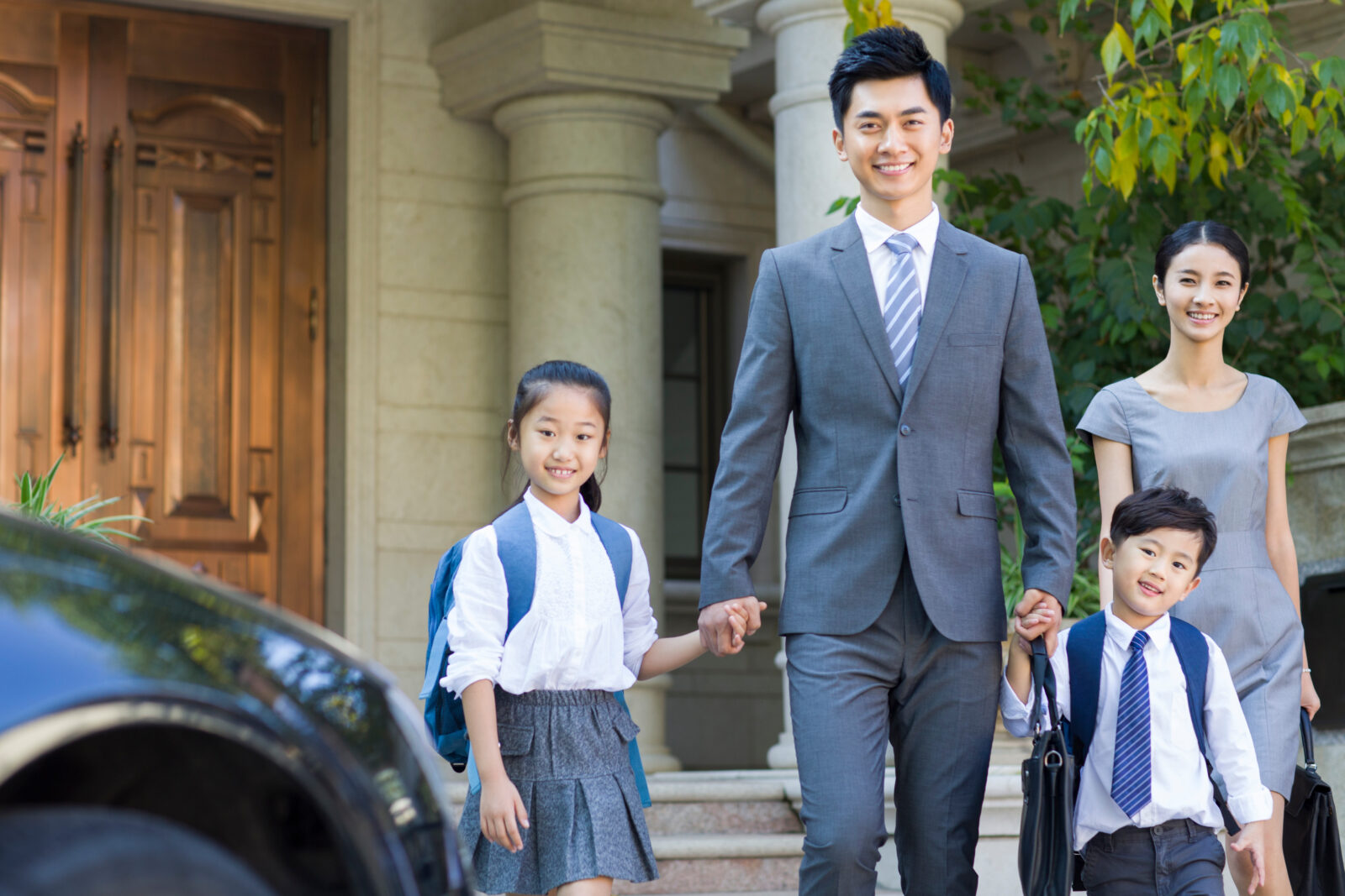 Young couple sending their children to school