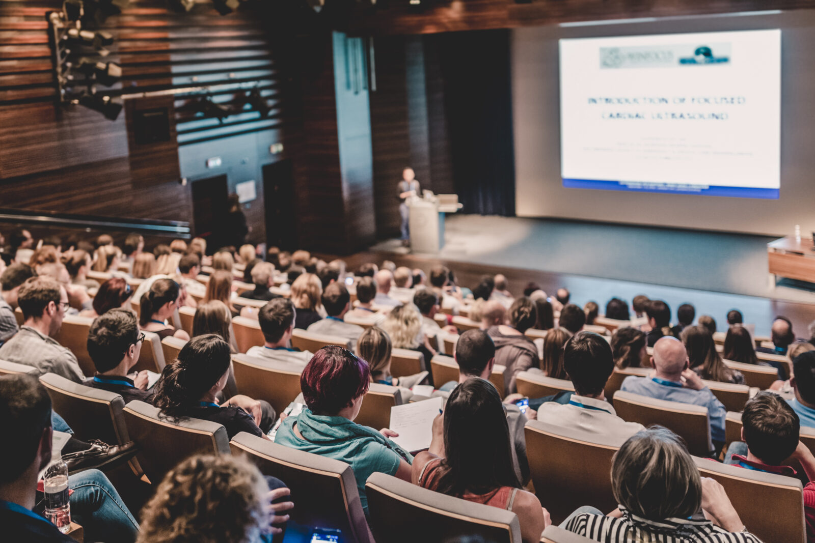 Business speaker giving a talk in conference hall.