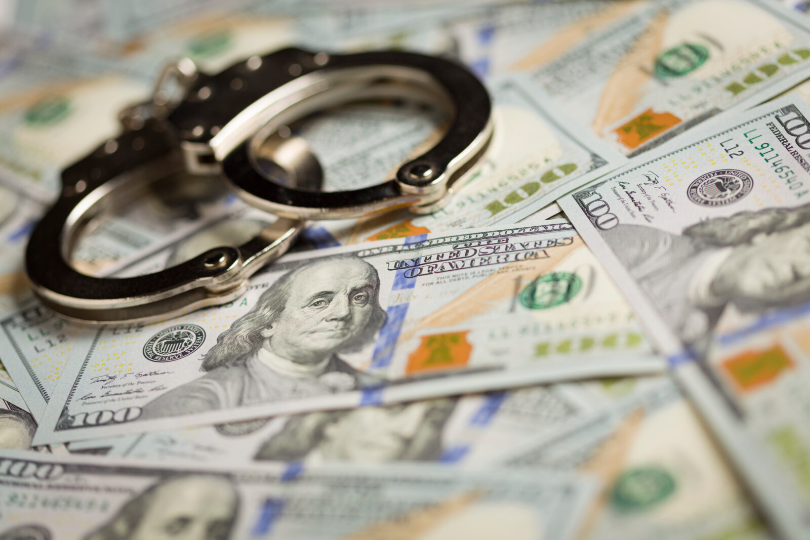 Handcuffs and Newly Designed One Hundred Dollar Bills