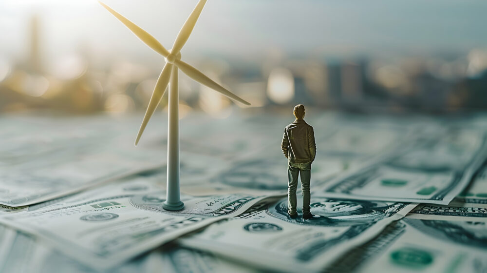 Person with Wind Turbine and Dollar Bills: Renewable Energy and Finance Integration Concept