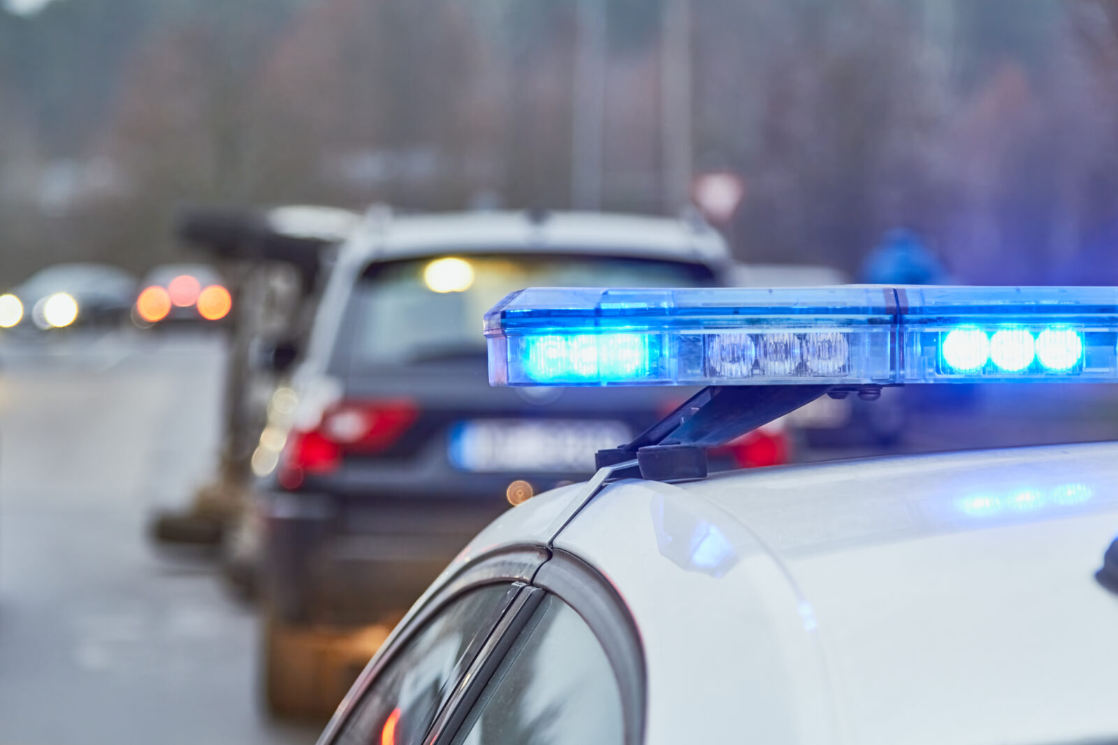 Blue lights of a police car at the scene of an accident