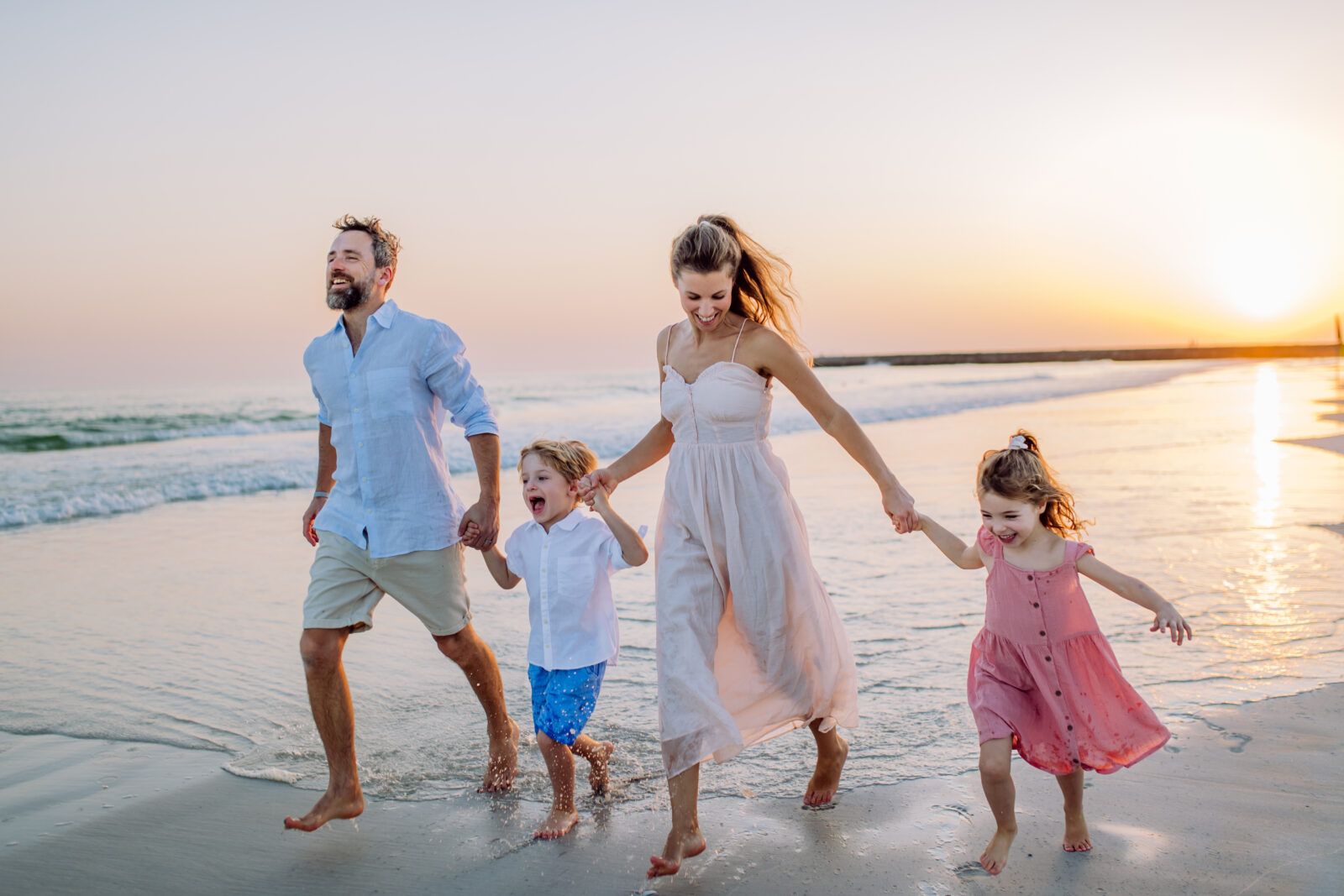 Happy family with little kids enjoying time at sea in exotic country.