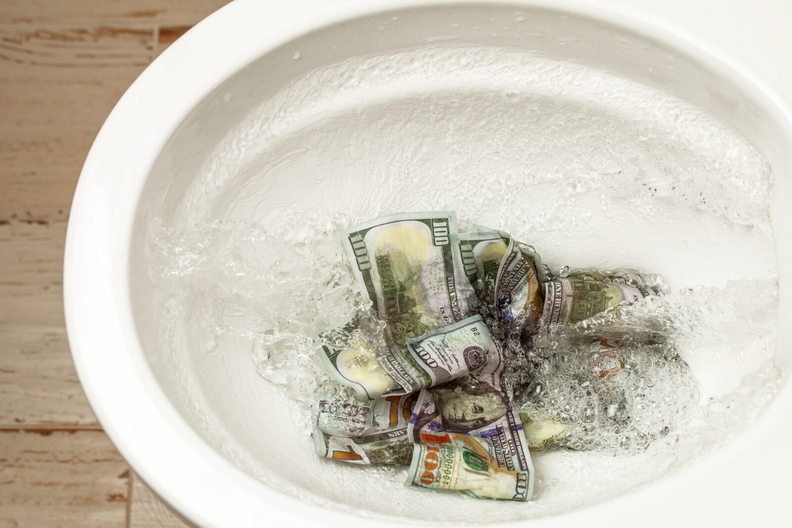 Loss of money. Bad investment or investment. Cash dollars are flushed into the toilet