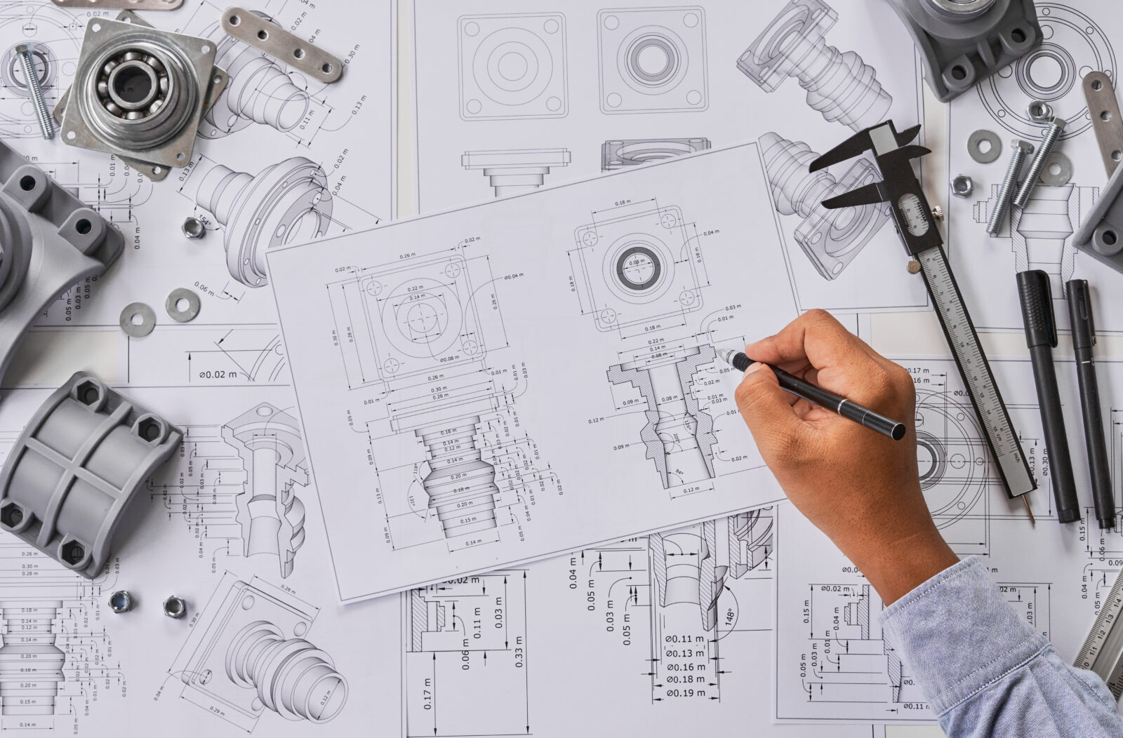 Engineer technician designing drawings mechanical parts engineering Engine.manufacturing factory Industry Industrial work project blueprints measuring bearings caliper tools
