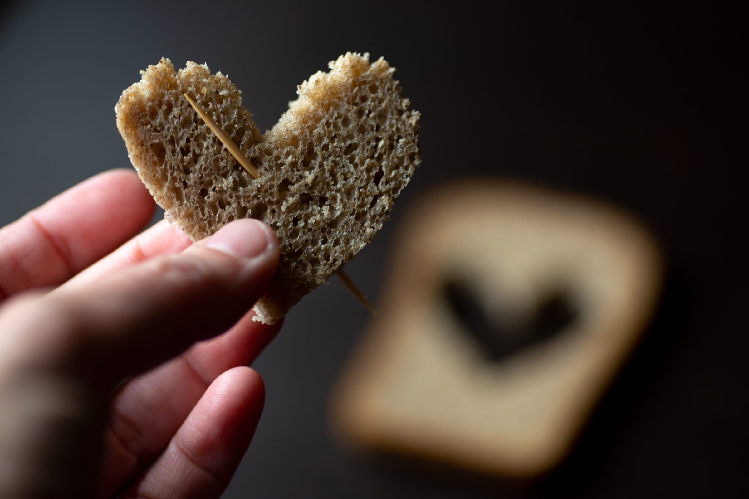 hearts carved from a piece of bread on a wooden table