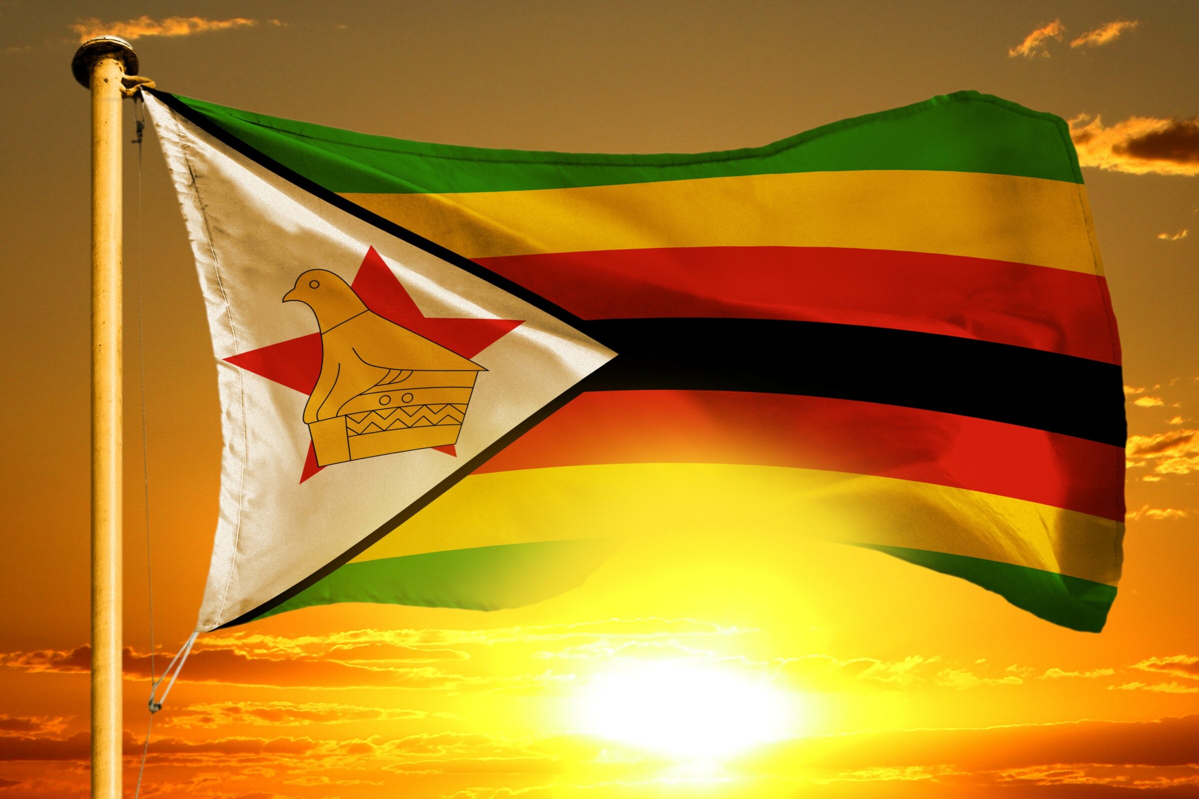 Zimbabwe flag against orange sunset