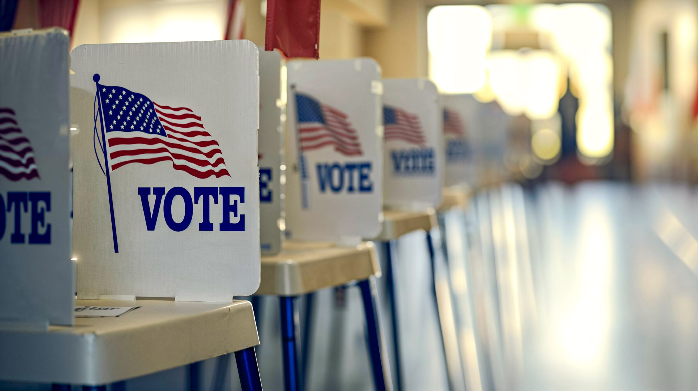 Line of voting privacy booths at an empty polling station, USA Election Day, copyspace