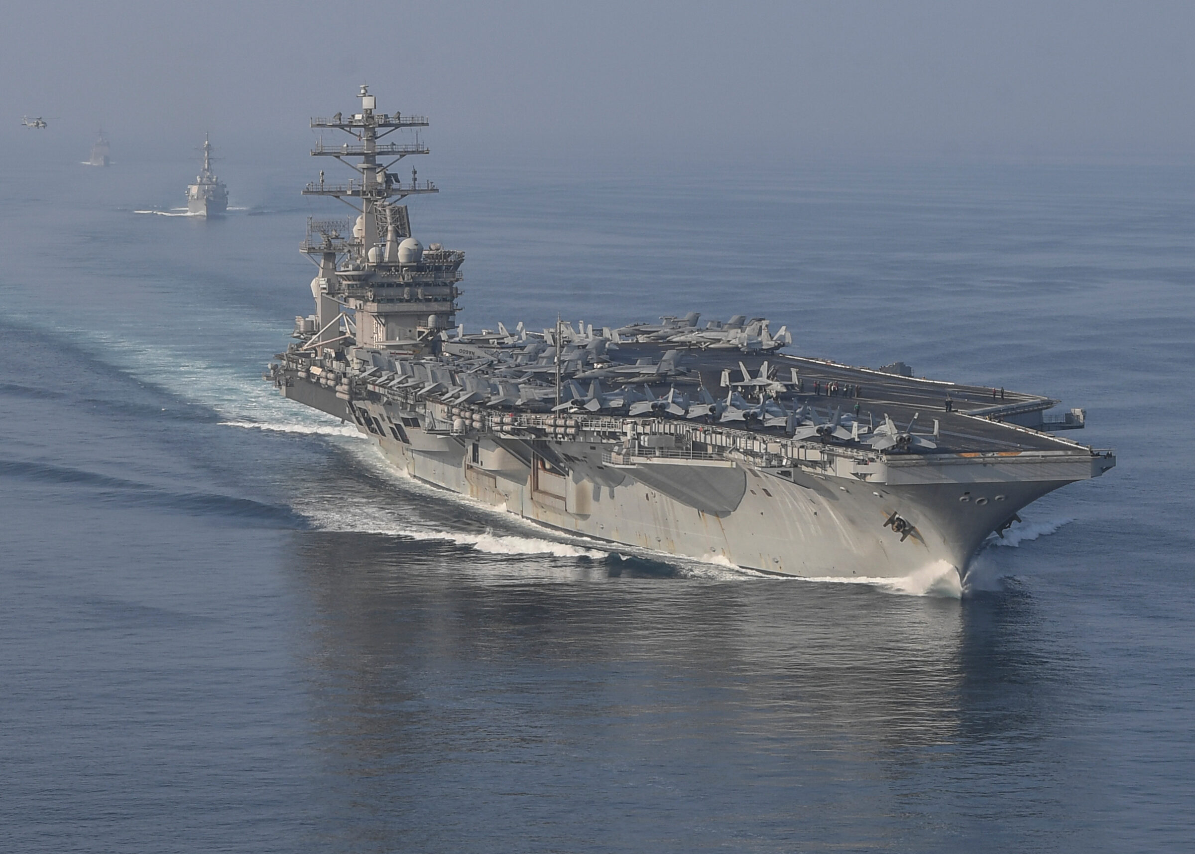 STRAIT OF HORMUZ U.S. Navy and Coast Guard ships participates in a photo exercise while transiting the Strait of Hormuz, Sioux City is deployed to the U.S. 5th Fleet area of operations to help ensure