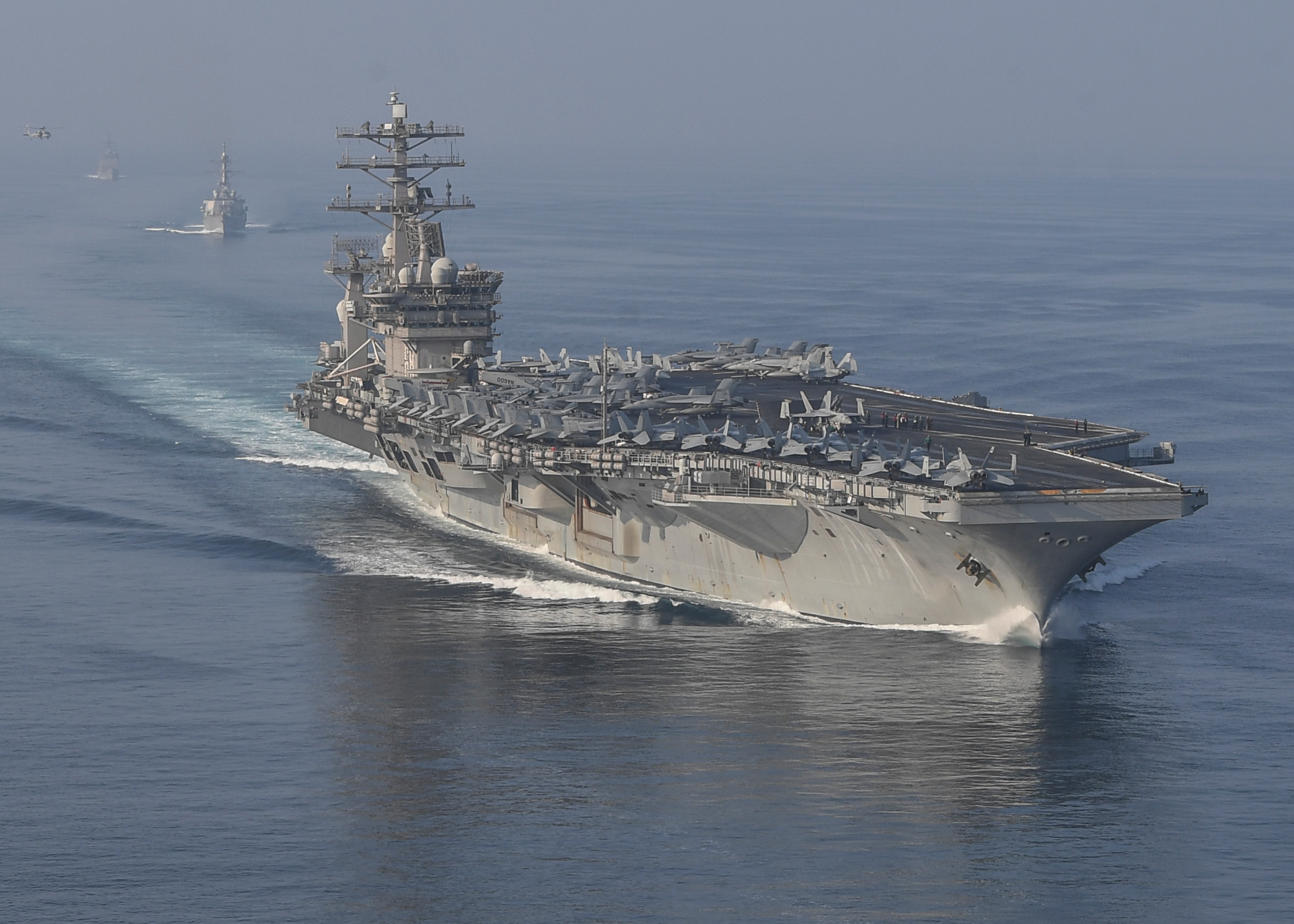 STRAIT OF HORMUZ U.S. Navy and Coast Guard ships participates in a photo exercise while transiting the Strait of Hormuz, Sioux City is deployed to the U.S. 5th Fleet area of operations to help ensure