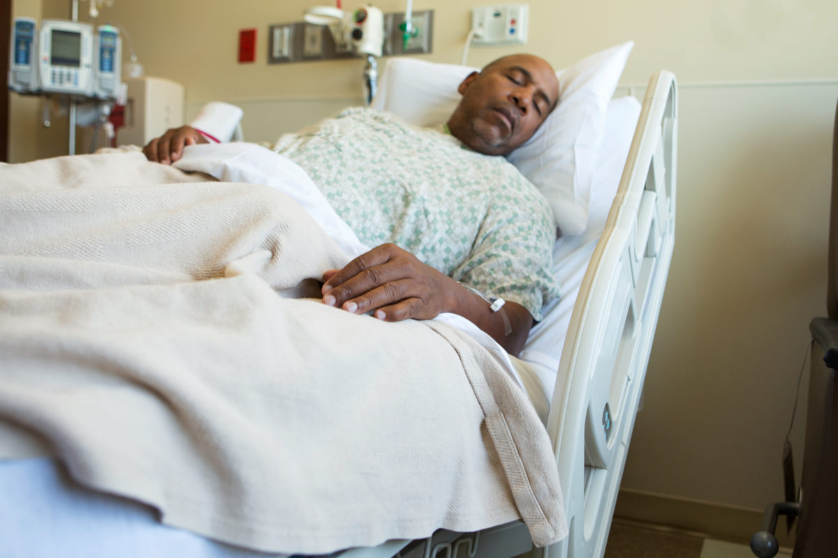 African American man in a hospital bed.