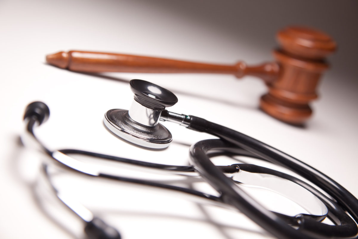 Gavel and Stethoscope on Gradated Background