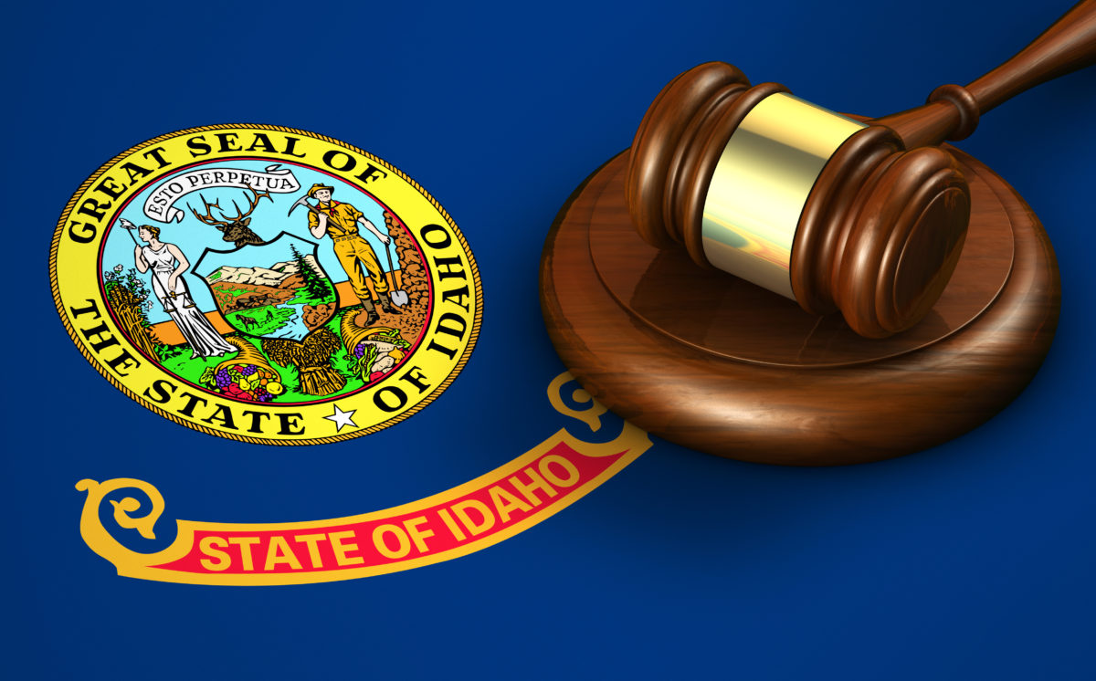 Idaho US state law, legal system and justice concept with a 3D rendering of a gavel on the Idahoan flag on background.