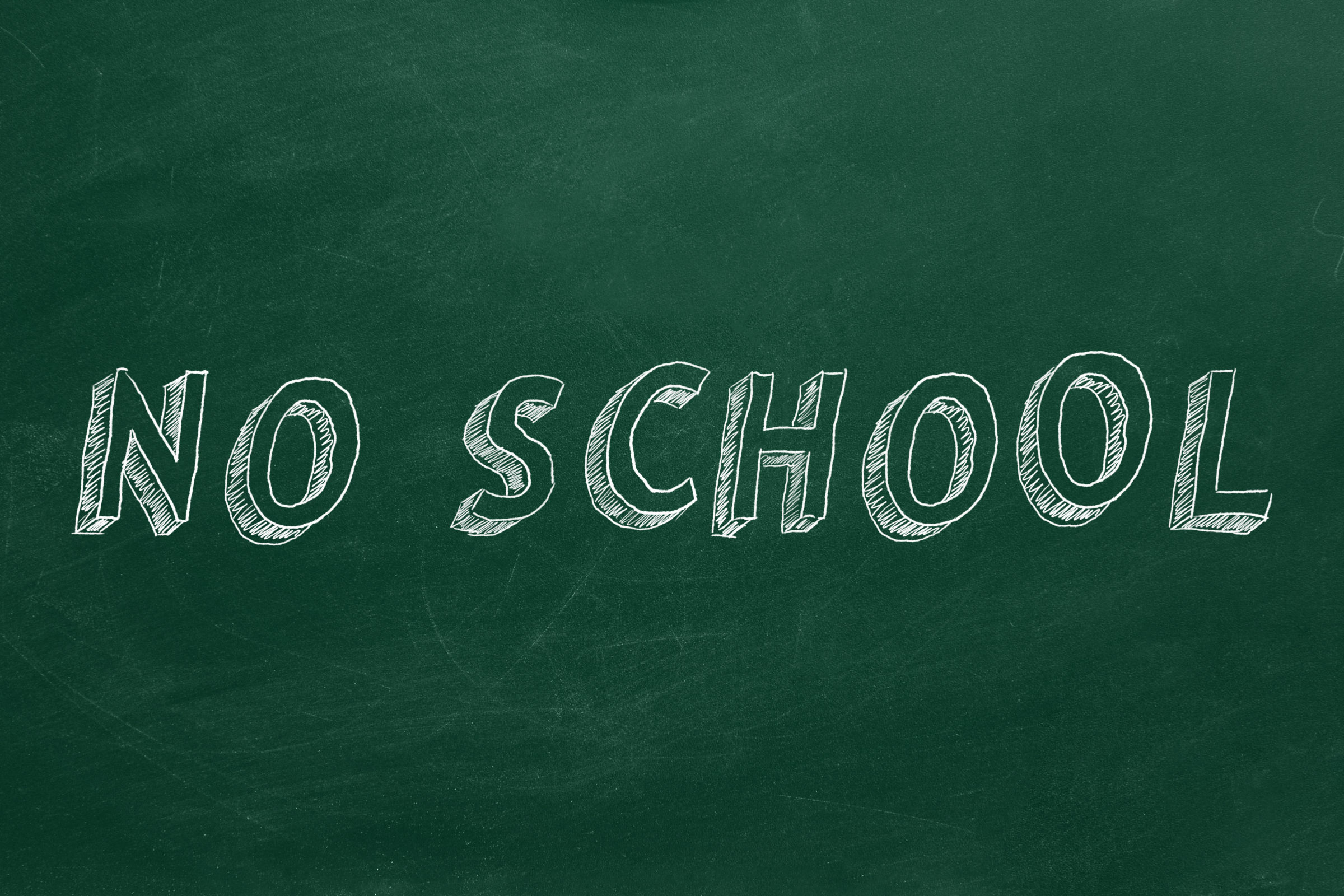 Hand drawing text "NO SCHOOL" on green chalkboard.