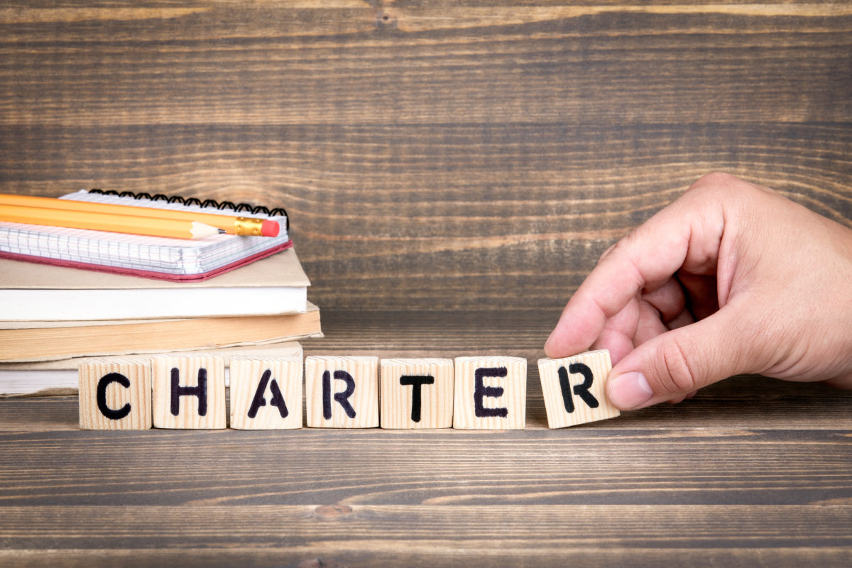 charter. Wooden letters on the office desk, informative and communication background