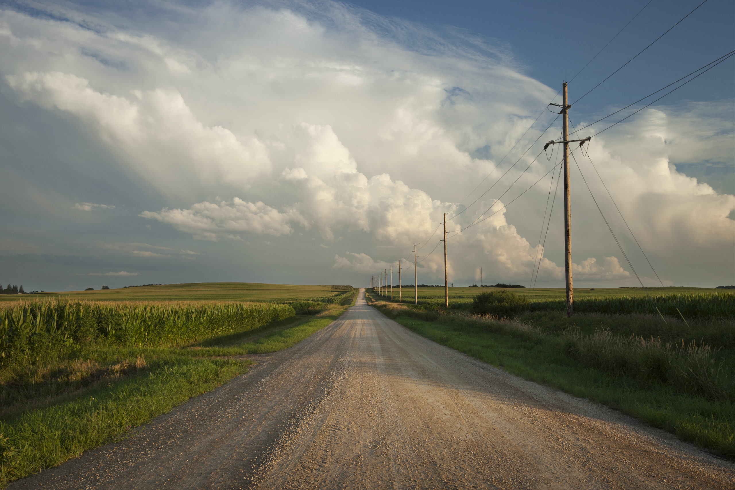 Rural Minnesota road with dramatic clouds at sundown