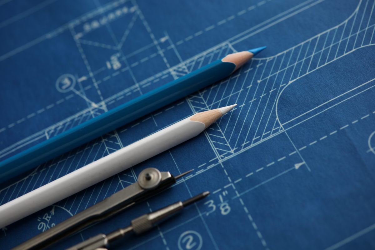 Drawing tools lying over blueprint paper