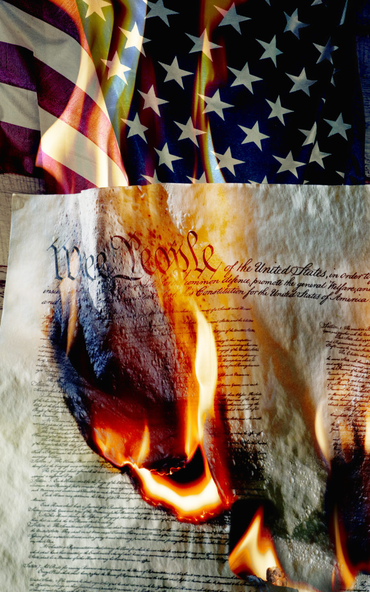 American flag with burning constition