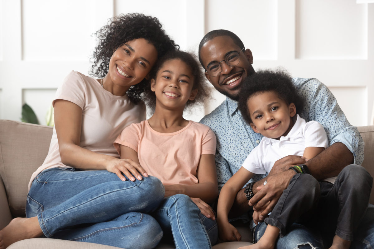 Portrait of black family with kids relax on couch