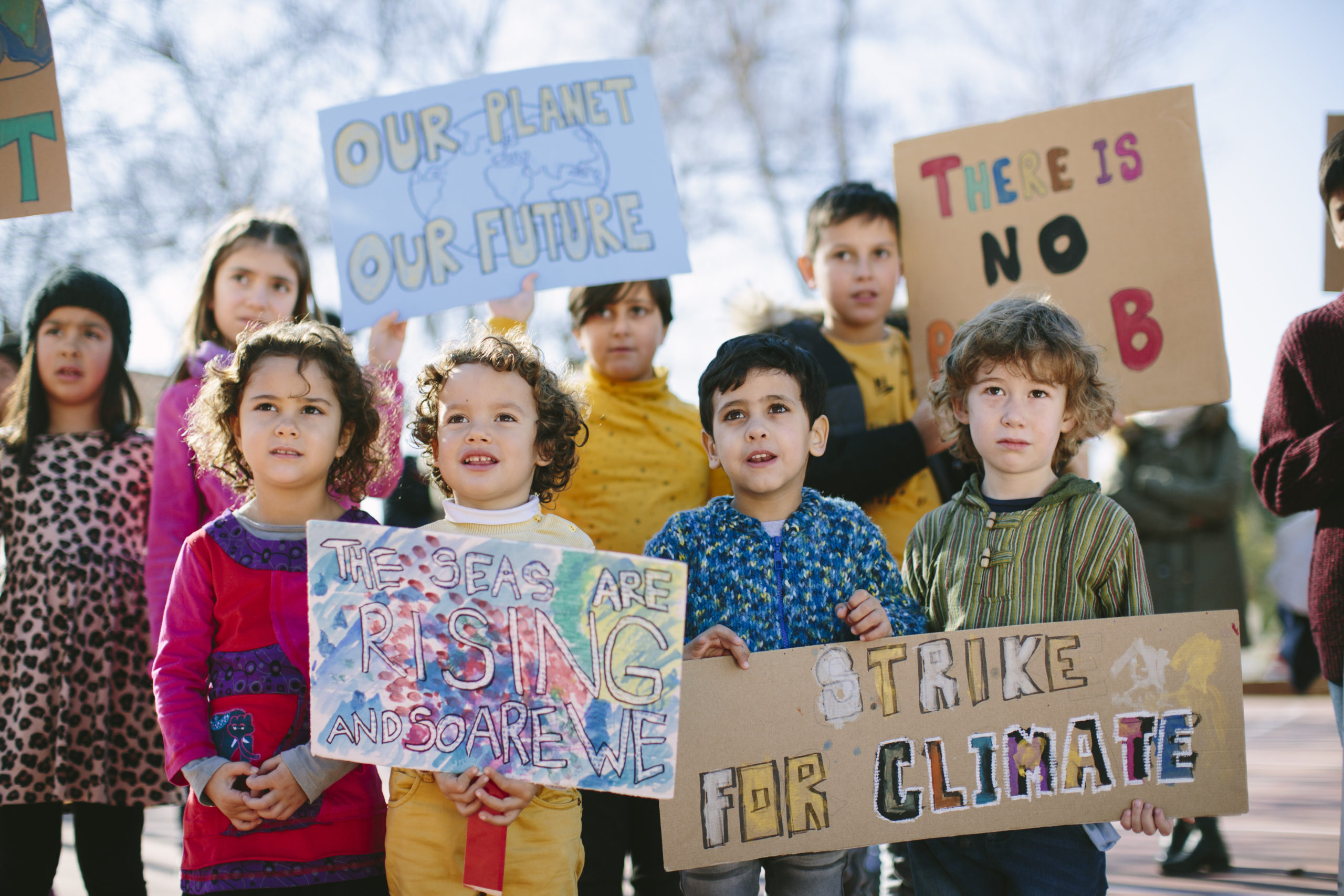 Group of young kids carrying banners