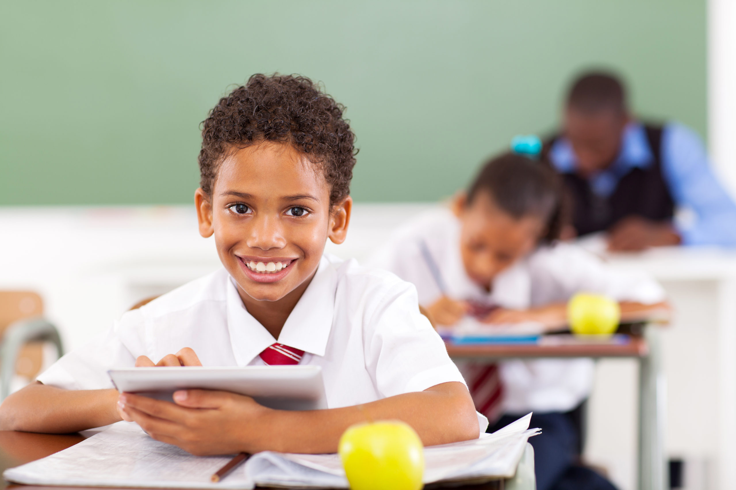 school boy using tablet computer