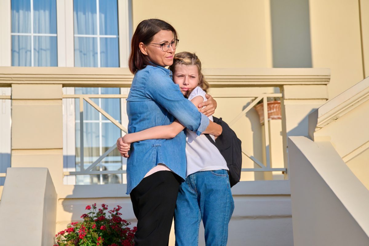 Mom and her daughter, a schoolgirl, are on the doorstep