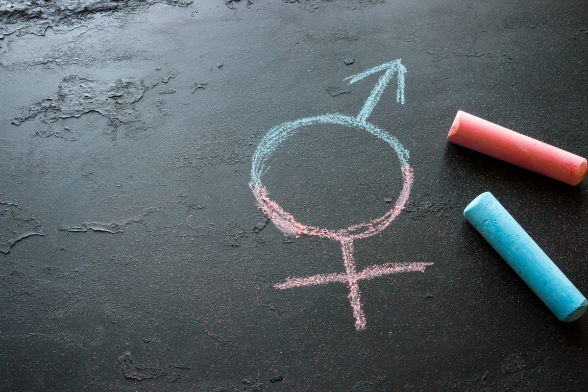 Colorful crayons and a symbol of a transgender